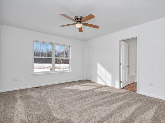 carpeted spare room with ceiling fan