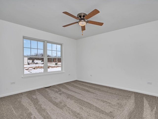 empty room featuring carpet floors and ceiling fan