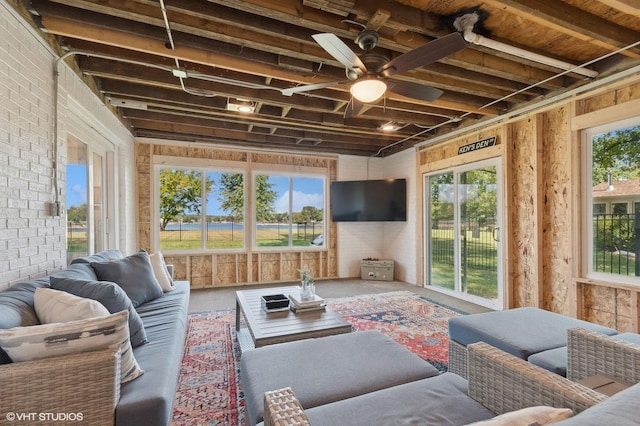 sunroom / solarium with plenty of natural light and ceiling fan