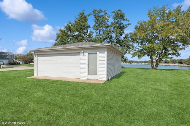 garage featuring a water view and a yard