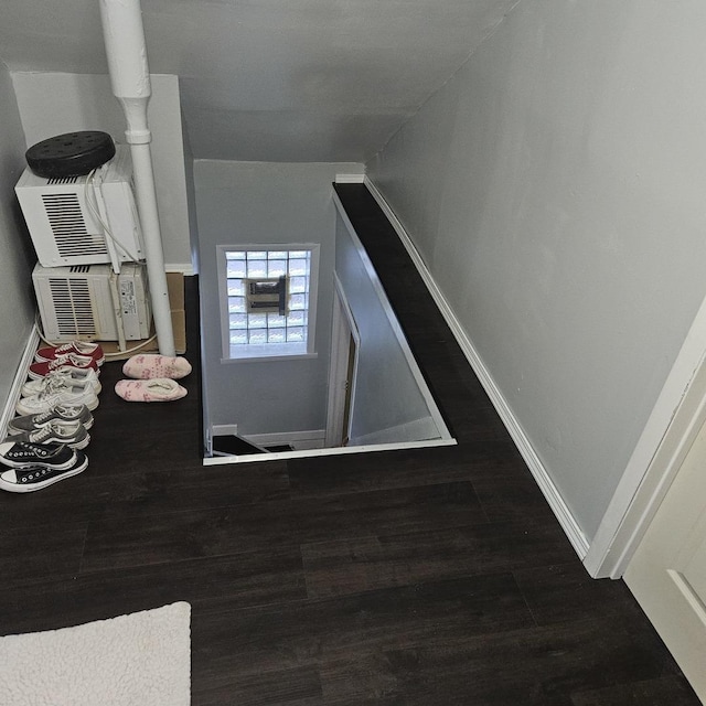 interior space with baseboards and wood finished floors