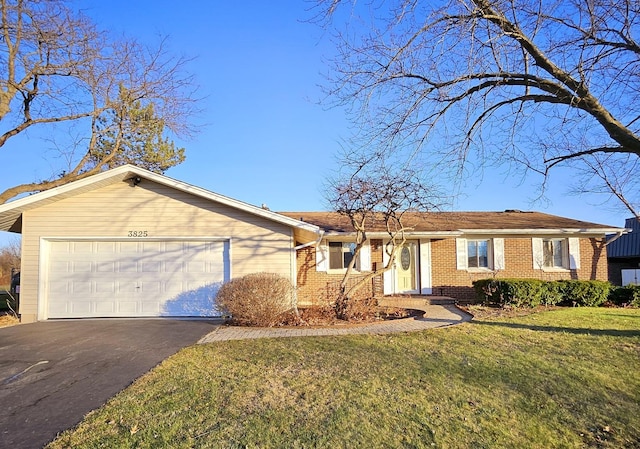 single story home featuring a garage and a front yard