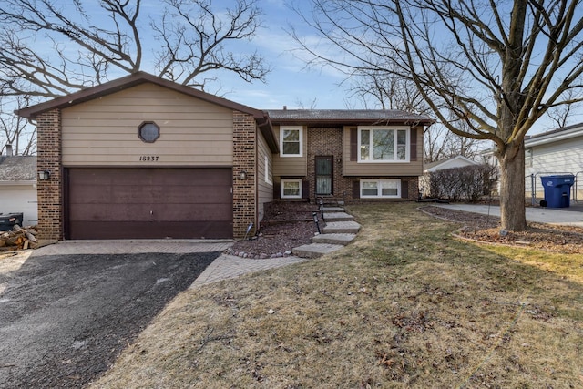 view of front of home featuring a garage and a front lawn