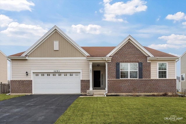 view of front of house featuring a garage and a front lawn