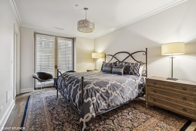 bedroom with crown molding and dark hardwood / wood-style flooring