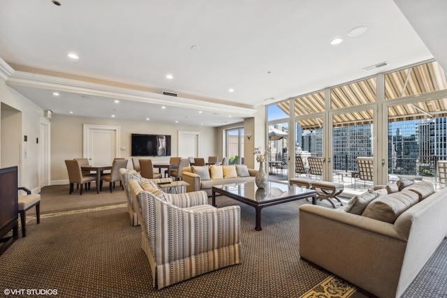 carpeted living room featuring floor to ceiling windows