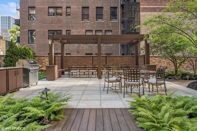 view of patio / terrace with area for grilling and a pergola