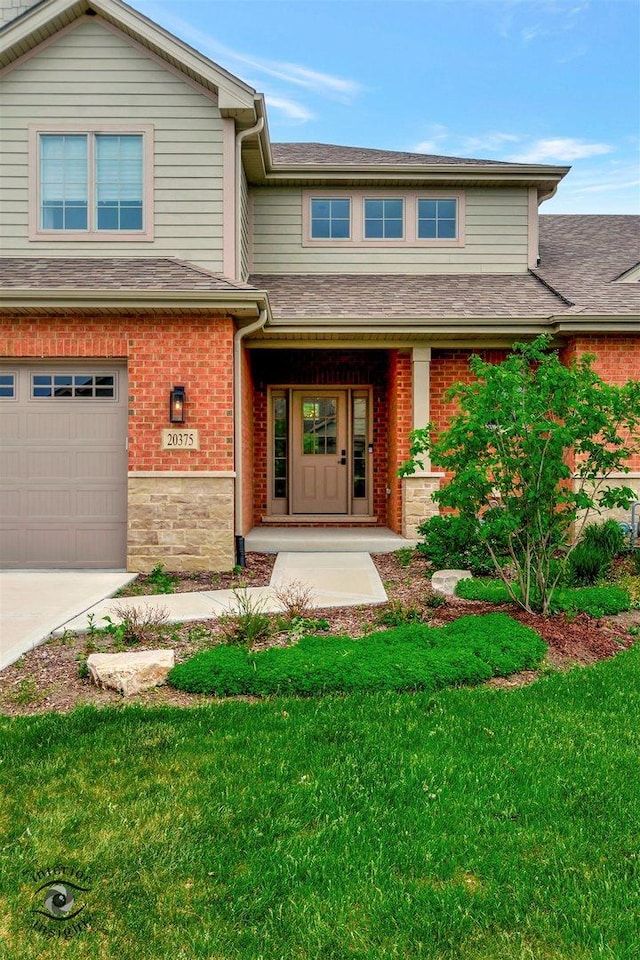 20375 Grosse Point Dr, Frankfort, IL 60423 - view of front of house with brick siding, a front yard, covered porch, and a garage