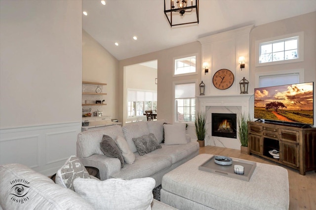 20375 Grosse Point Dr, Frankfort, IL 60423 - living room featuring high vaulted ceiling, plenty of natural light, a premium fireplace, light wood-style floors, and recessed lighting