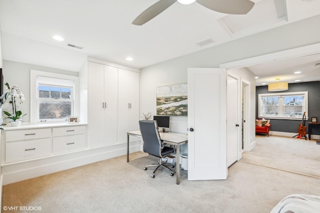 office space with light carpet and ceiling fan