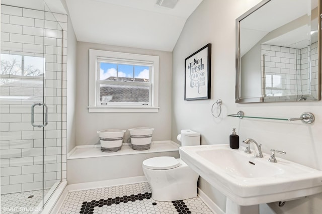 bathroom featuring vaulted ceiling, sink, tile patterned flooring, toilet, and a shower with door