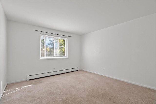 carpeted empty room featuring a baseboard heating unit