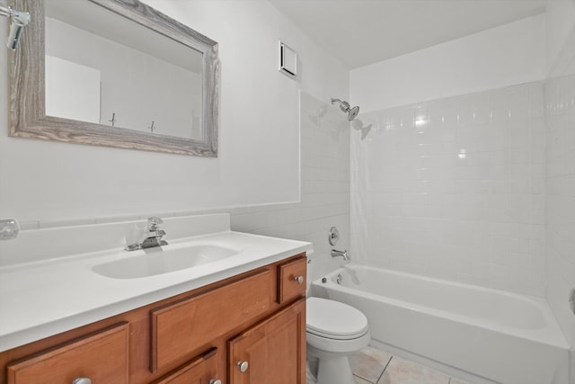 full bathroom with tile patterned flooring, vanity, tiled shower / bath combo, and toilet