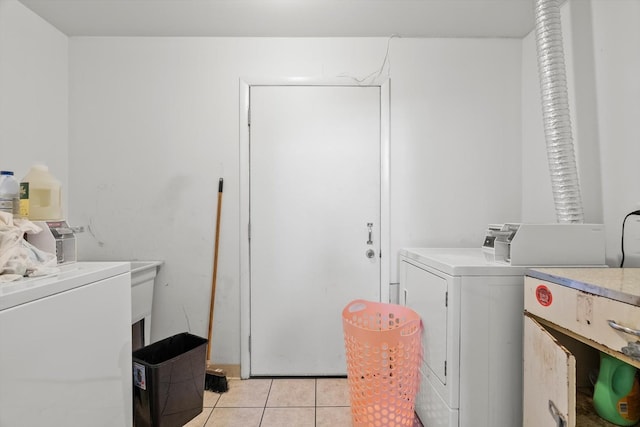 laundry area featuring independent washer and dryer and light tile patterned flooring