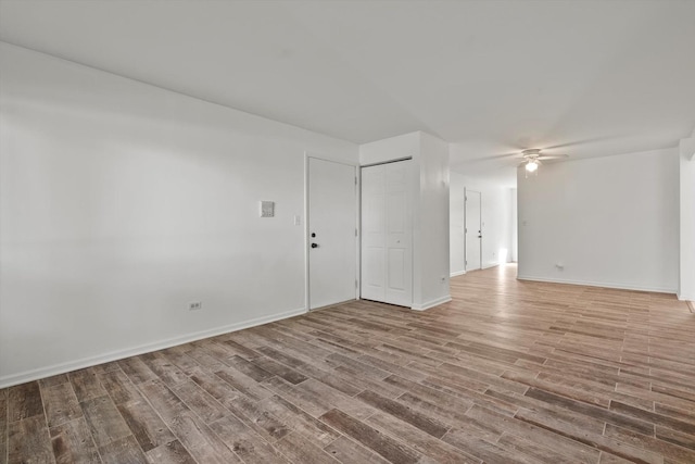 empty room featuring wood-type flooring and ceiling fan