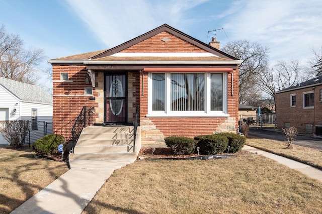 bungalow-style house with a front lawn