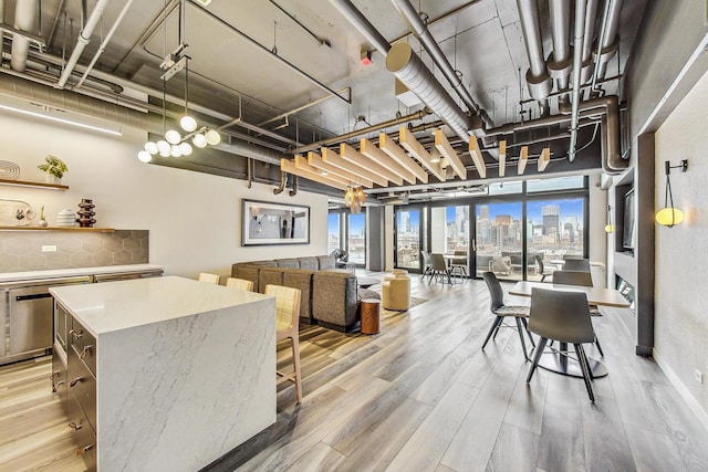 dining area featuring a city view and light wood-style floors