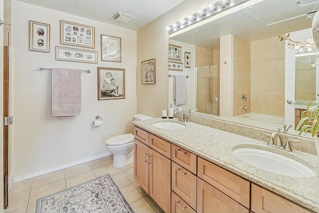 bathroom with tile patterned flooring, visible vents, a tile shower, and a sink