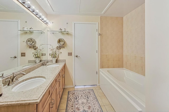 bathroom with double vanity, a bathing tub, a sink, and tile patterned floors