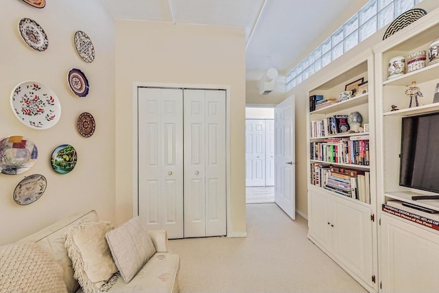 sitting room featuring light carpet