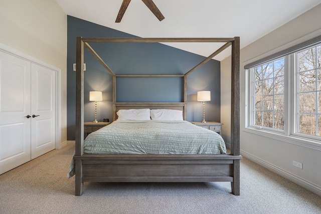 bedroom featuring baseboards, carpet, a ceiling fan, and vaulted ceiling