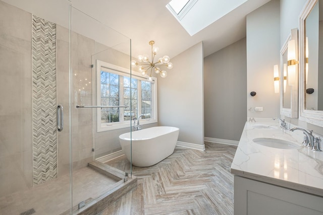 bathroom with double vanity, a shower stall, a freestanding bath, and a sink