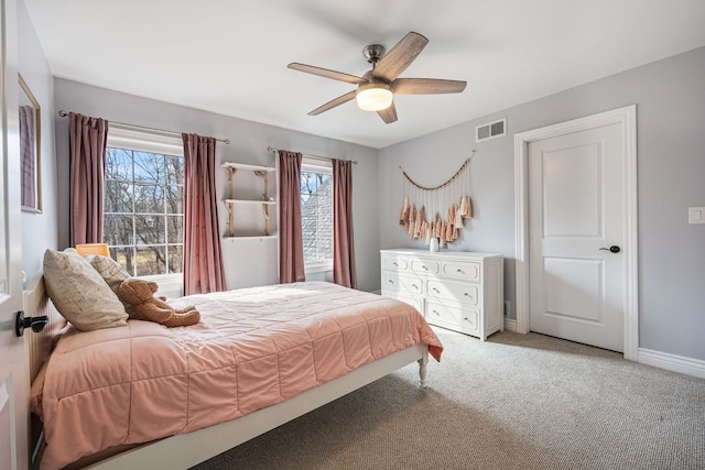 bedroom featuring visible vents, light carpet, baseboards, and ceiling fan