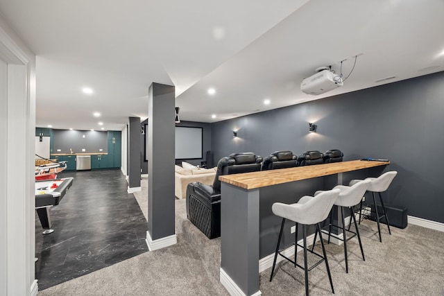 cinema room with a bar, recessed lighting, and baseboards