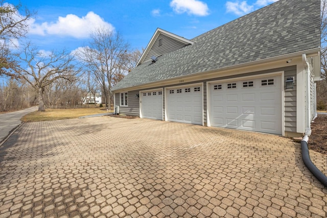 garage with decorative driveway