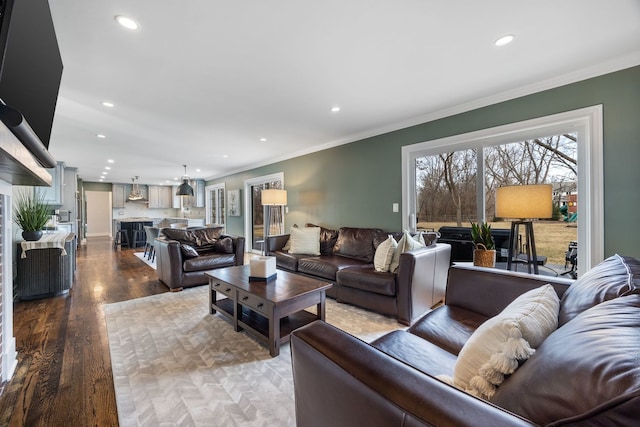 living area featuring recessed lighting, wood finished floors, and ornamental molding