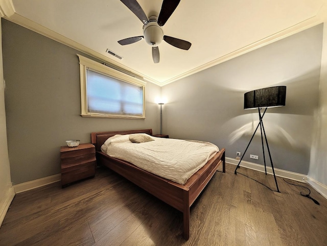 bedroom featuring ornamental molding, dark wood-type flooring, and ceiling fan