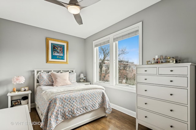 bedroom featuring ceiling fan, baseboards, and wood finished floors