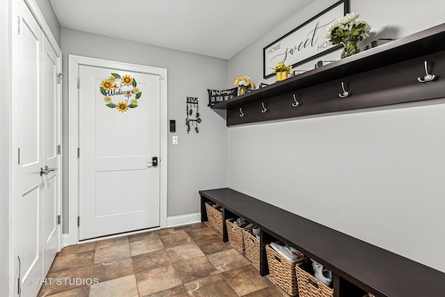 mudroom with stone finish floor and baseboards