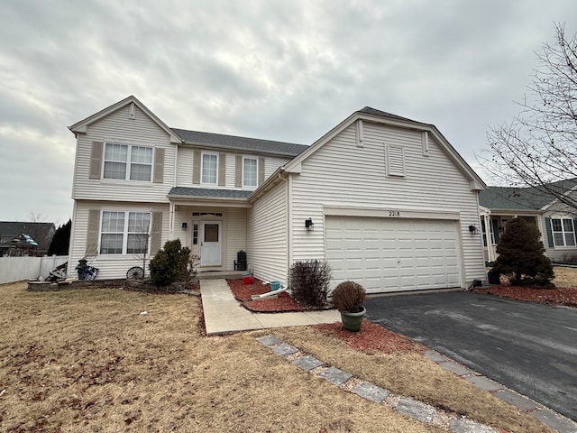 view of front property with a garage and a front yard