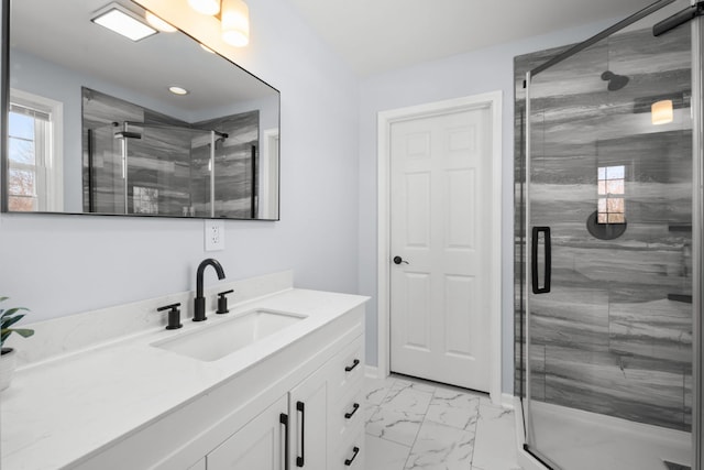 bathroom featuring vanity and a shower with shower door