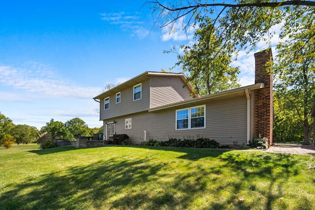 rear view of property featuring a yard