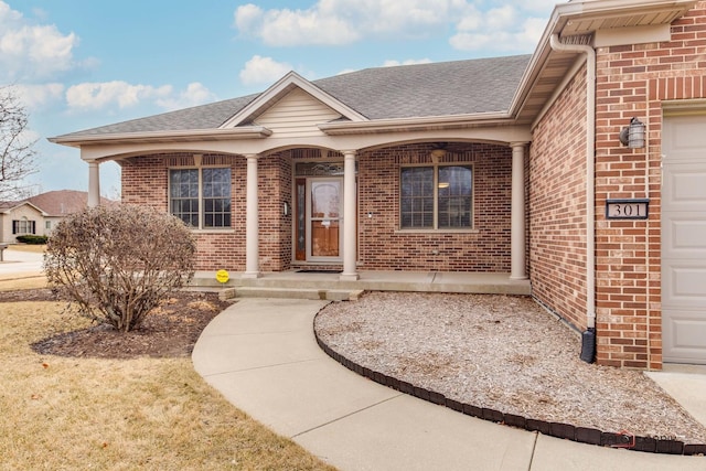 doorway to property featuring a garage and covered porch