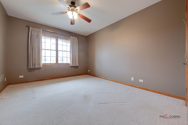 carpeted spare room featuring vaulted ceiling and ceiling fan