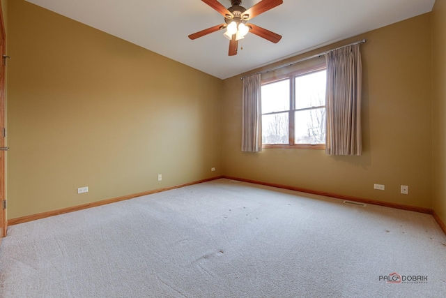 carpeted spare room featuring vaulted ceiling and ceiling fan