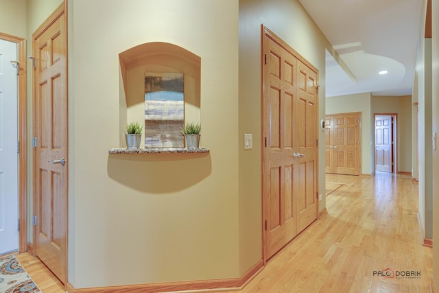 hallway with light hardwood / wood-style flooring