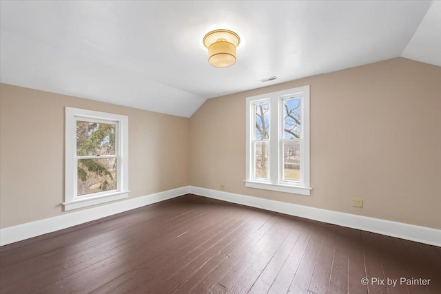 additional living space featuring lofted ceiling and dark hardwood / wood-style flooring