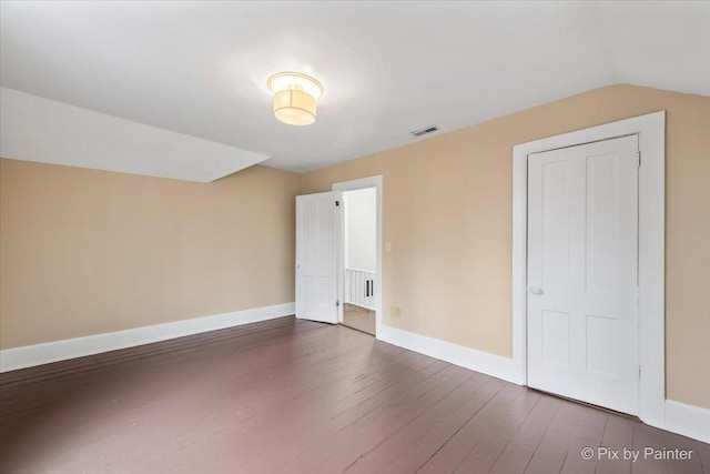 bonus room featuring dark hardwood / wood-style flooring and vaulted ceiling