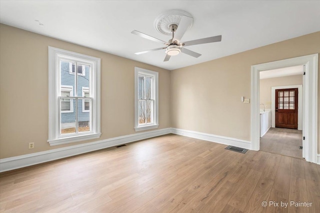 spare room with light hardwood / wood-style flooring and ceiling fan