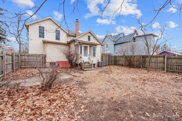 rear view of property featuring cooling unit