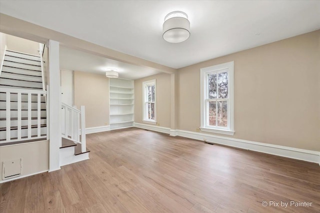 interior space with built in features and light hardwood / wood-style floors