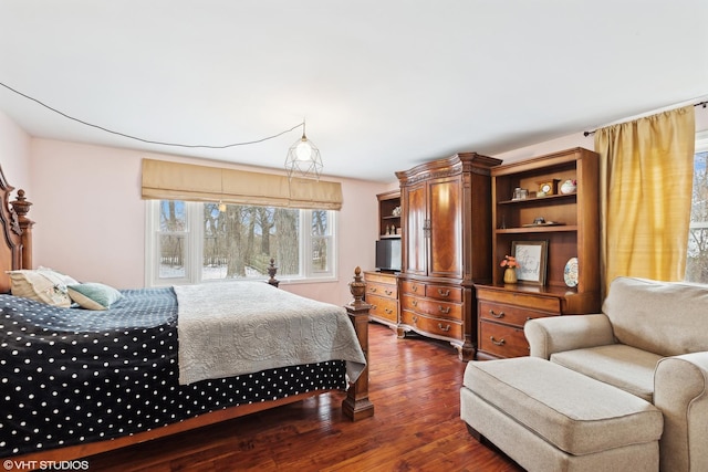 bedroom with dark wood-style flooring