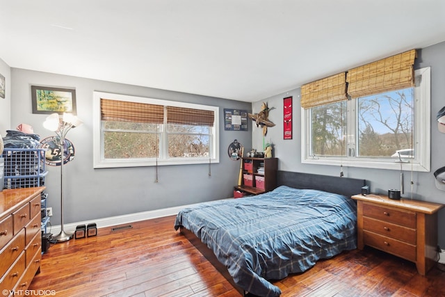 bedroom with visible vents, baseboards, and wood-type flooring