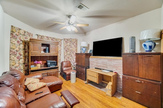 living room featuring wood-type flooring and ceiling fan