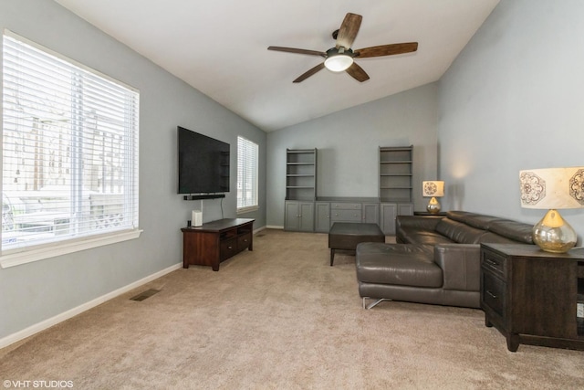 living room featuring lofted ceiling, light colored carpet, and ceiling fan