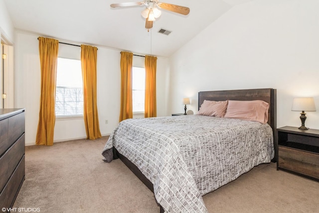 bedroom with ceiling fan, light colored carpet, and vaulted ceiling